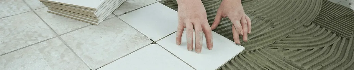 Professional installing white tile floors in Tempe, AZ